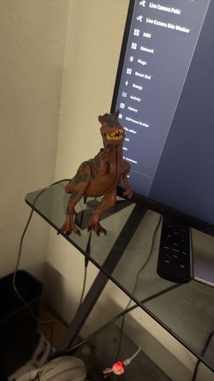 The RF gateway ESP32-C3, mounted inside a toy dinosaur, sitting next to the Home Assistant dashboard